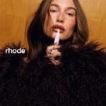Hailey Bieber poses for Rhode’s Peptide Lip Tint in Cinnamon Roll