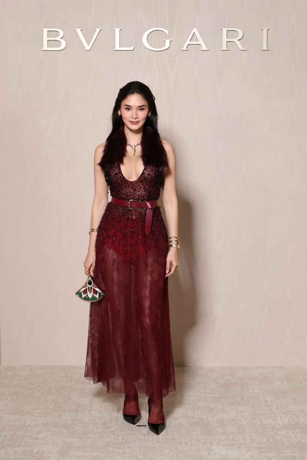 Pia Wurtzbach wearing a burgundy embellished gown at BVLGARI ICONS Minaudière celebration Paris 2026