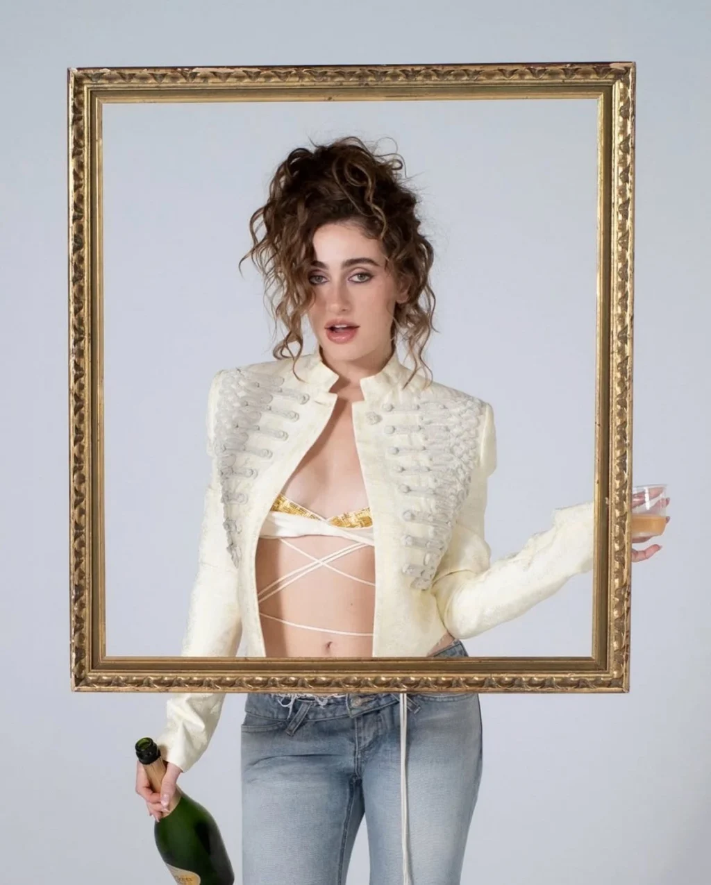 Rachel Sennott wearing an ivory cropped military-style jacket with wrap bralette and light-wash jeans for Perfect Magazine.