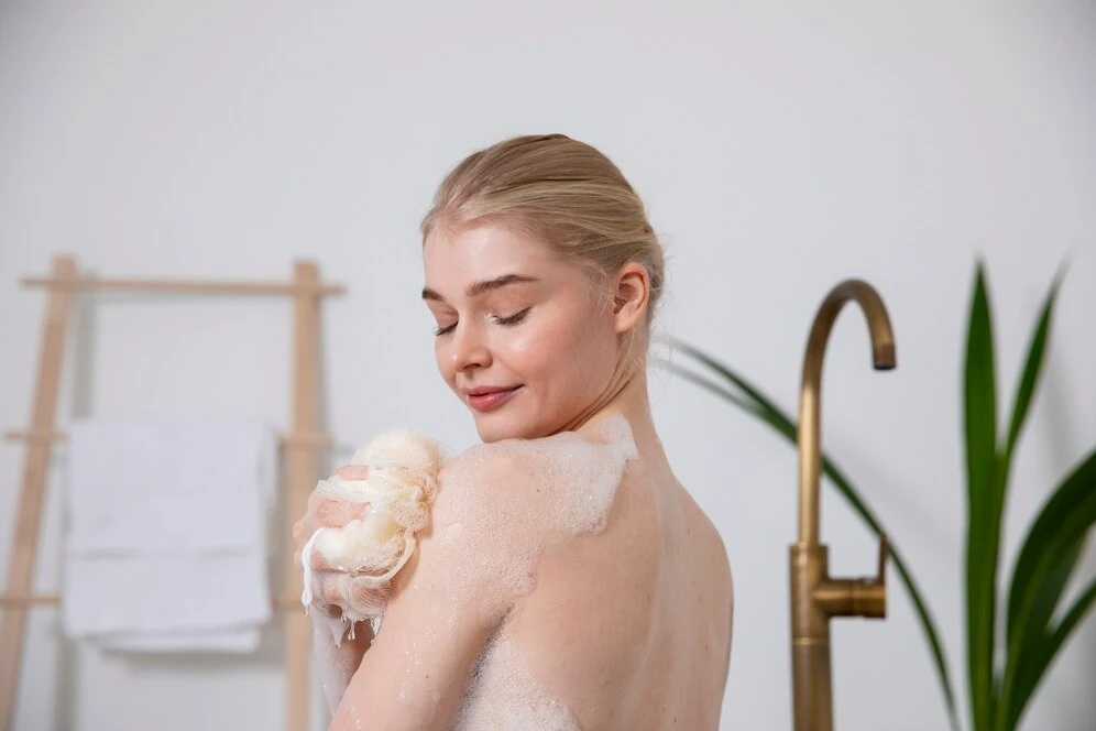 Close up smiley woman holding bath sponge